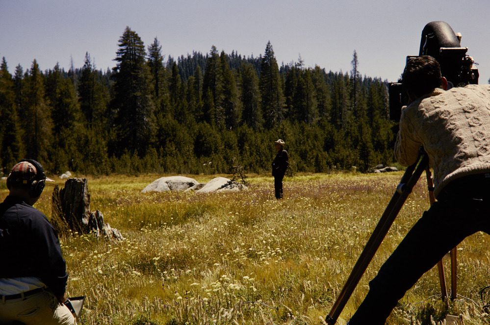 NPS Director Horace Albright standing in a field, while being filmed by a crew. Photo courtesy of U.S. National Park Service. Credit: Carl G. Degen Jr.